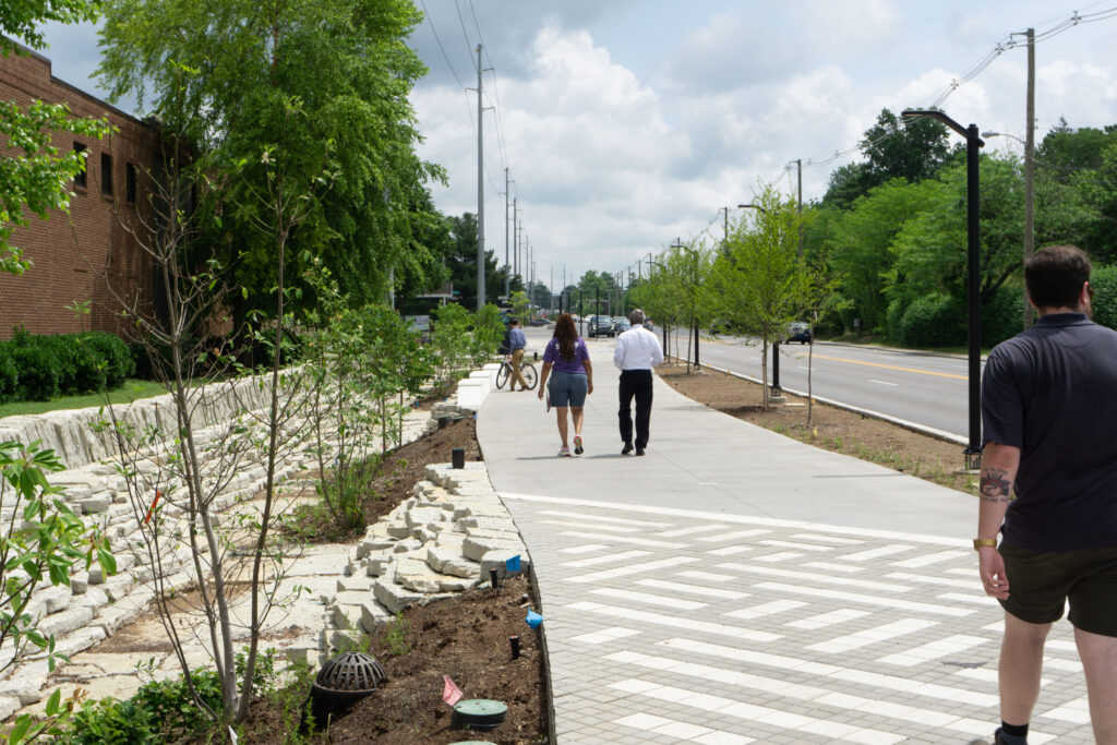 Pedestrians and cyclists walking down shared use trail