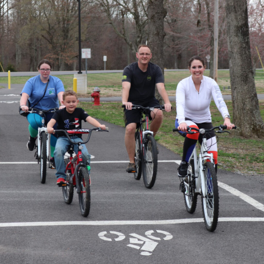 Family riding bikes on multi-use trail